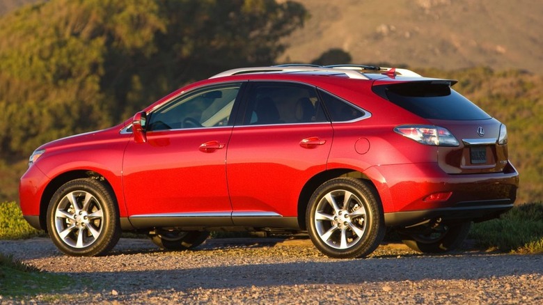 A red 2011 RX 350 parked outside on gravel.
