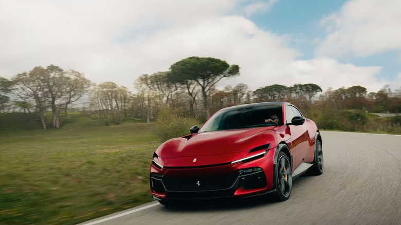 Front dynamic shot of a red Ferrari Purosangue.