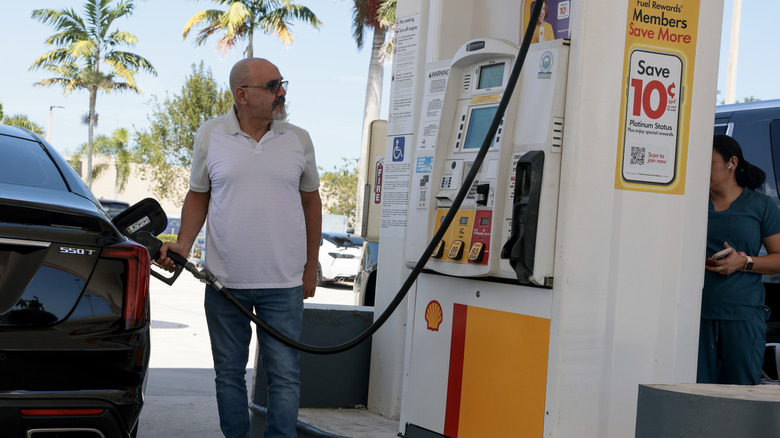 Pierre Boulos fills his vehicle with fuel at a gas station on April 13, 2026 in Miami, Florida.