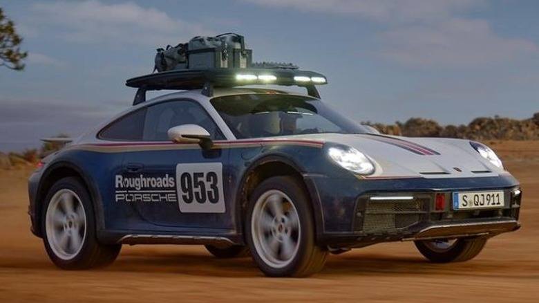 A Porsche 911 Dakar racing in the desert