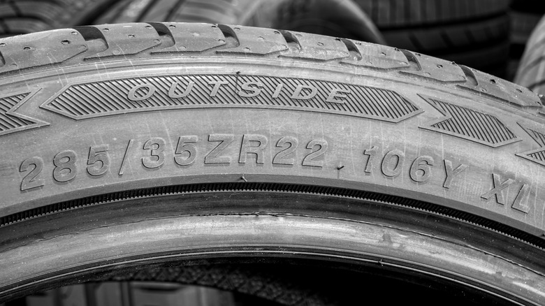 The sidewall markings of a new tire with a 106 load index and Y speed rating