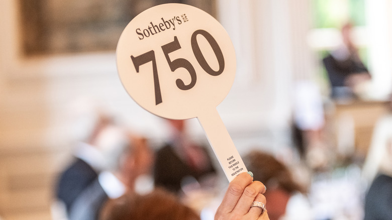 A sotheby's auction paddle successful nan air