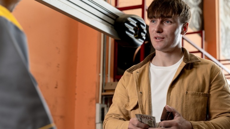 Man paying for truck repairs at a garage