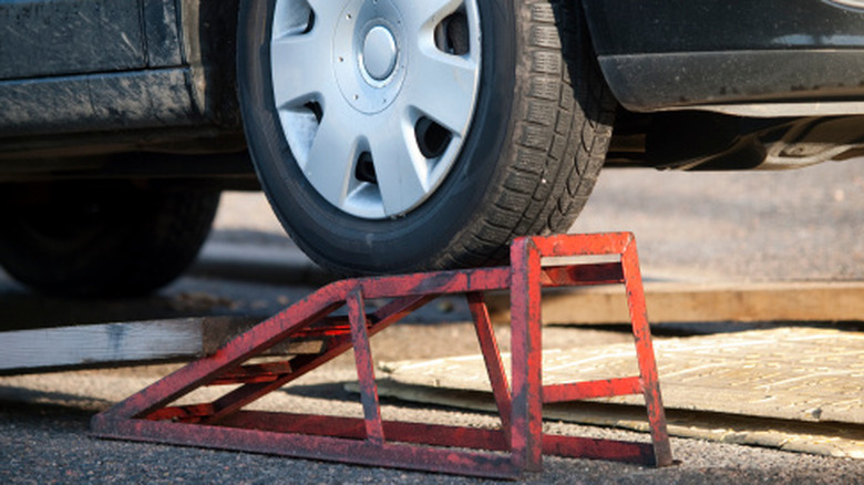 A car parked on a metal ramp for service work