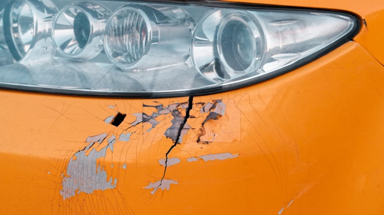 Cracked bumper with plastic cover in need of repair