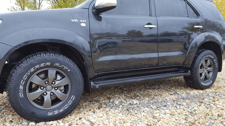 A black SUV with fixed running boards