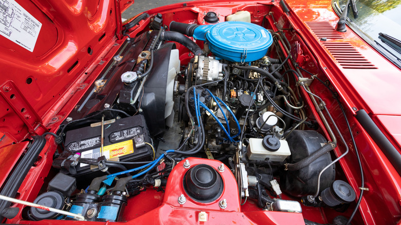 The engine bay of a red Mazda RX-7