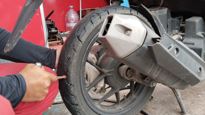 Repairing a tubeless motorcycle tire in a workshop