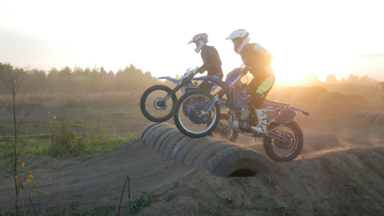 Riding an enduro motorcycle fitted with tubed tires on the dirt track