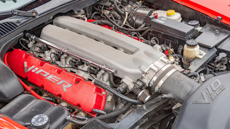 A closeup of the 505-cubic-inch V10 engine under the hood of a red Dodge Viper