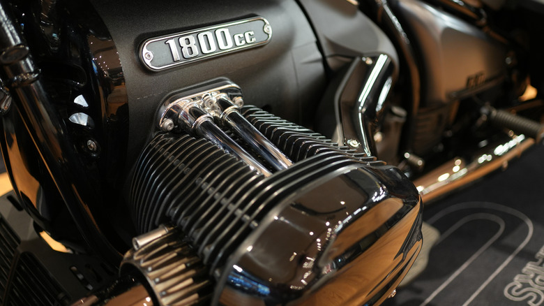 A side view of a BMW motorcycle showing the cooling fins on its horizontally-opposed "boxer" engine.