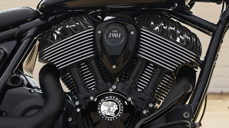 A side view of an Indian V-twin motorcycle engine showing silver cooling fins against black-painted components.