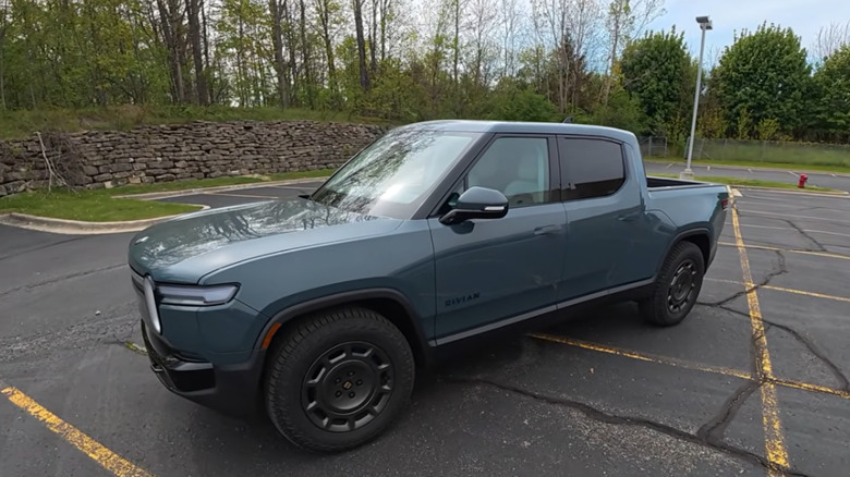 A 2026 Rivian R1T Quad Motor parking across multiple spaces