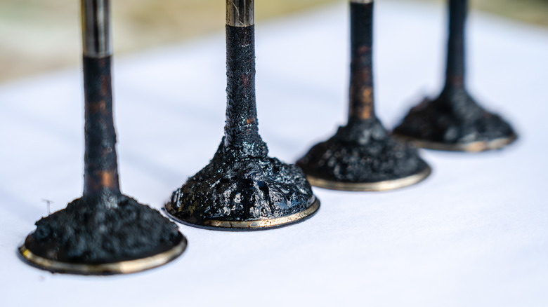 Engine valves covered up with carbon deposits