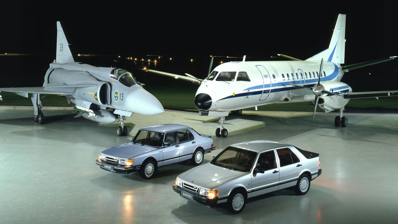 A collection of Saab products including a fighter jet, airplane, and two production cars: the Saab 900 and Saab 9000