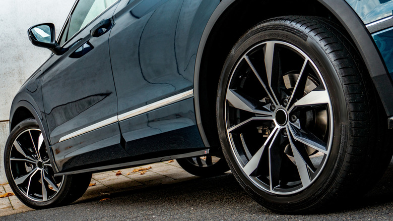 A blue car fitted with aftermarket alloy wheels