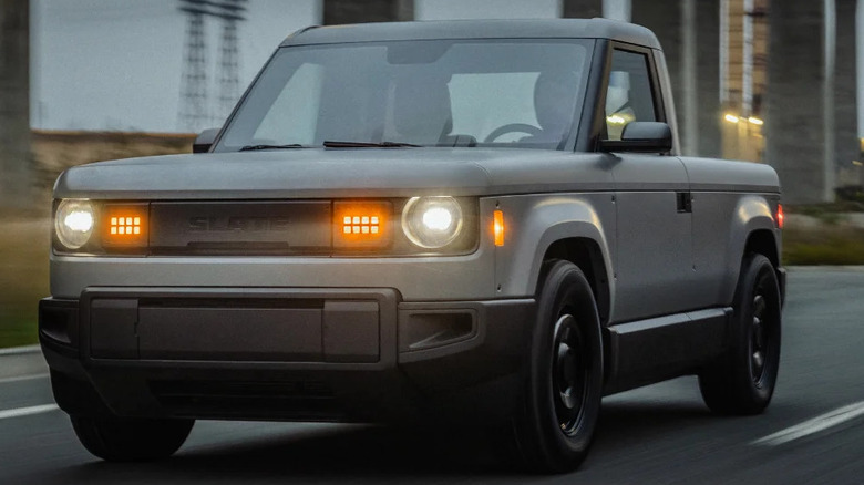 The entry-level Slate truck with its headlights on, on a highway