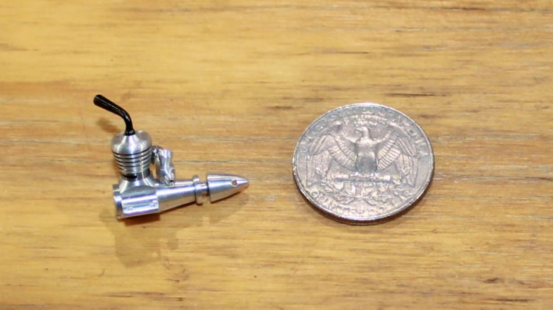 Valentine Nano Bee diesel engine next to a quarter.