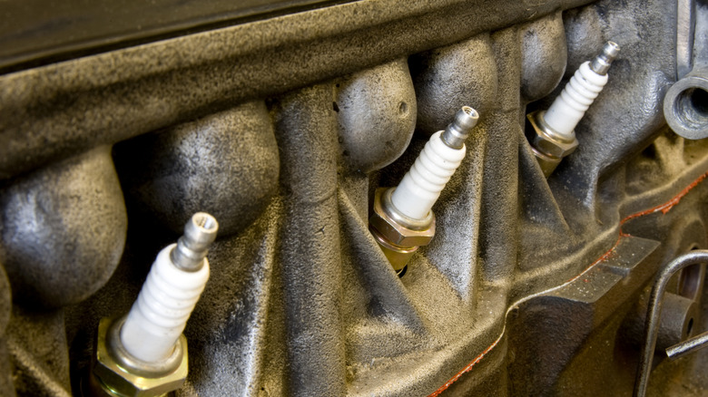 A row of spark plugs in an old engine