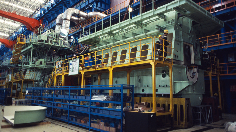 A Wärtsilä diesel engine with workers next to it.