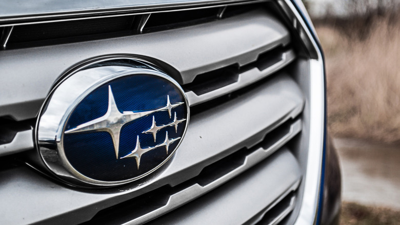 The Subaru logo on the grill of a car