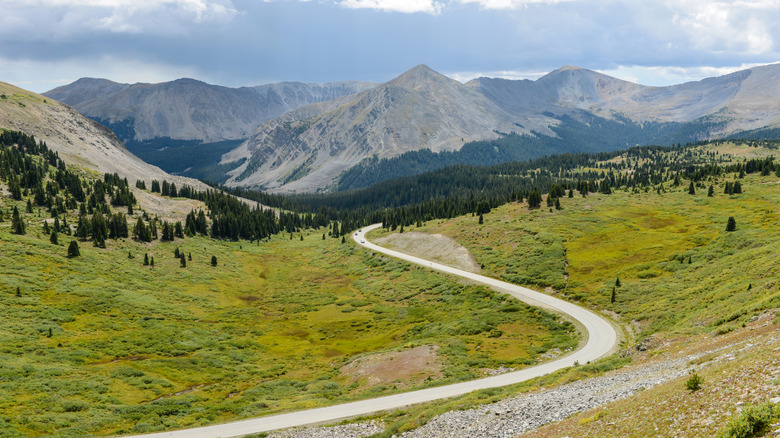 A road winding through Cottonwood Pass in the Spring with mountains in the background