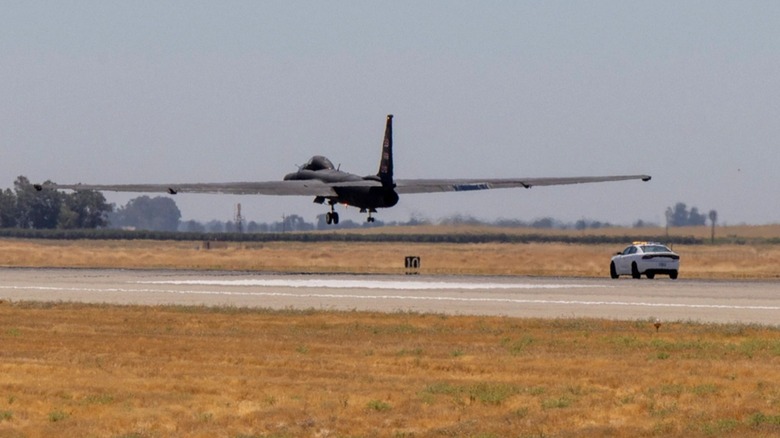 A U-2 coming in for a landing, assisted by a chase vehicle
