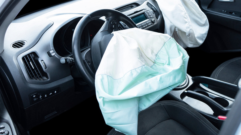 the interior of a car with the airbags deployed