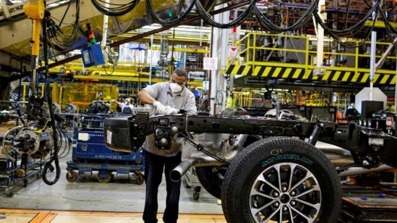 A worker assembling a vehicle at Ford's Dearborn, Michigan, facility