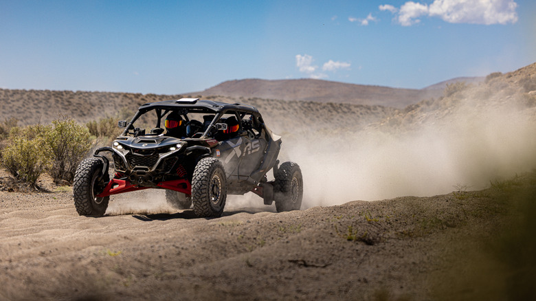 A 2026 Can-Am Maverick R MAX blasting down a sandy stretch of desert