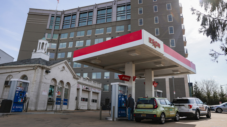 A man looks at gas prices listed on a gas pump at an Exxon station on March 13, 2026 in Washington, DC. Gas prices have risen 23 percent since the start of the United States conflict with Iran.