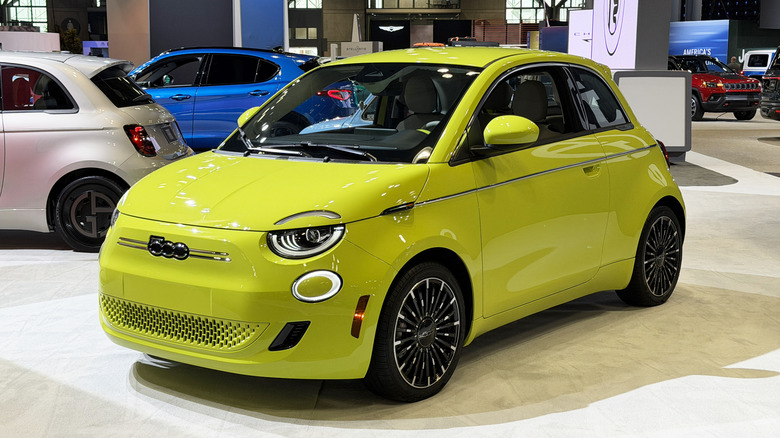 Front 3/4 view of a bright green Fiat 500e at the New York Auto Show