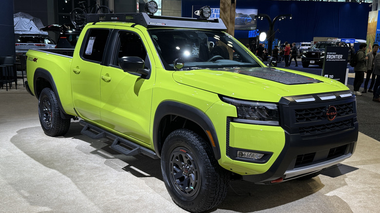 Front 3/4 view of a green Nissan Frontier at the New York auto show