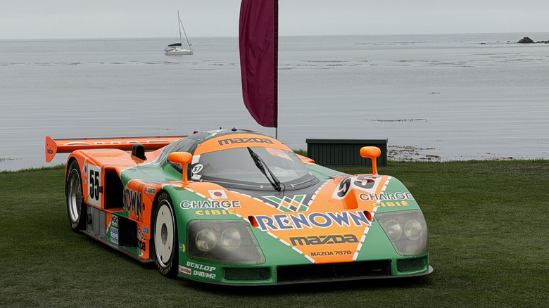A Mazda 787B race car parked at the Pebble Beach Concours d'Elegance