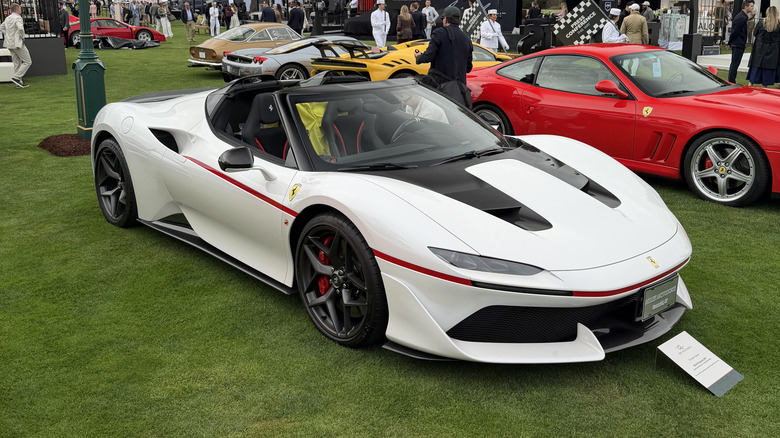 Front 3/4 view of a white Ferrari J50 on the lawn at The Quail