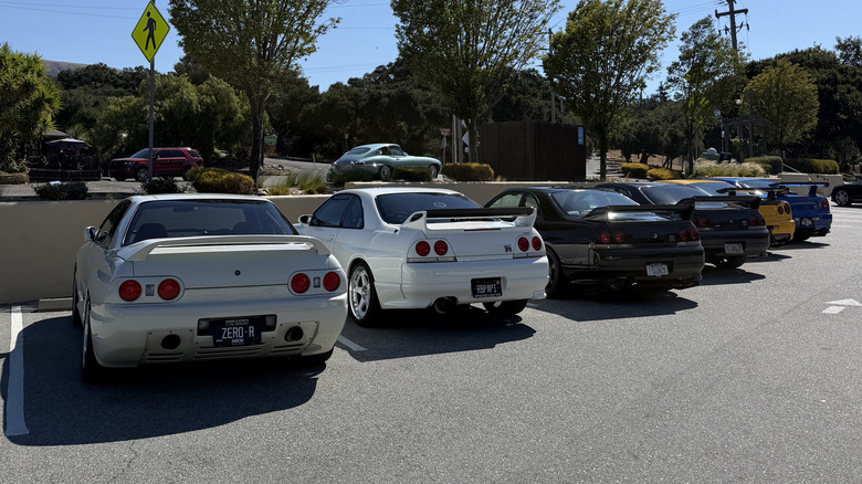 A bunch of Nissan Skyline GT-Rs all in a line.