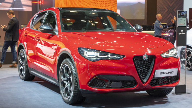 A red Alfa Romeo Stelvio on diplay at a car show.