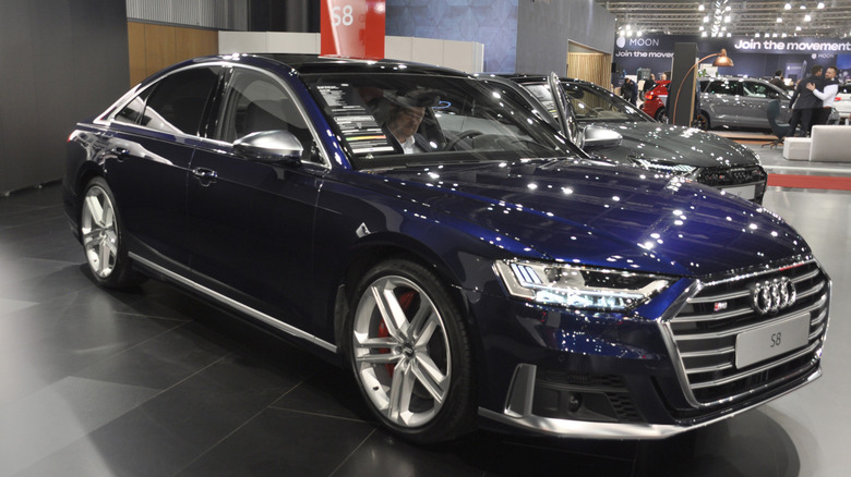 Audi S8 with a driver inspecting the cabin.
