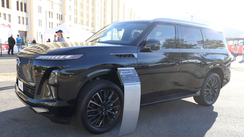 An Infiniti QX80 parked in a city.