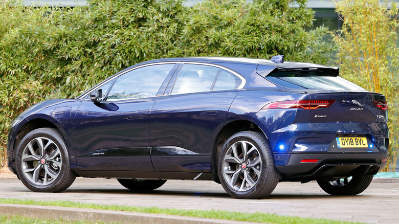 A blue Jaguar I-PACE in a parking lot.