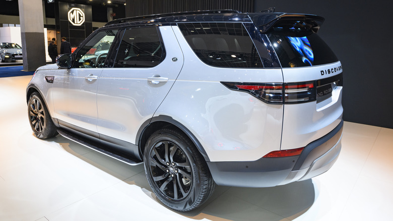A white Land Rover Discovery with black trim on display.