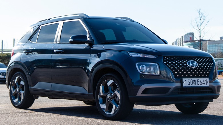 A blue Hyundai Venue parked in a lot.