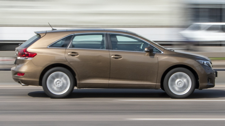 A brown Toyota Venza in motion on the highway.