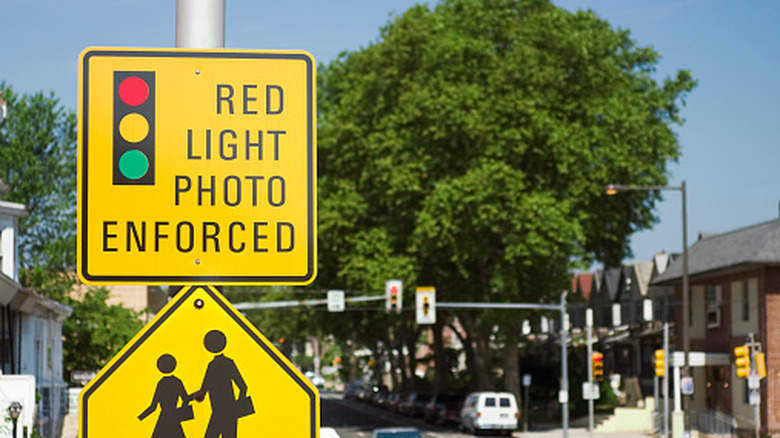 A sign showing that a red light camera exists at an intersection crosswalk.
