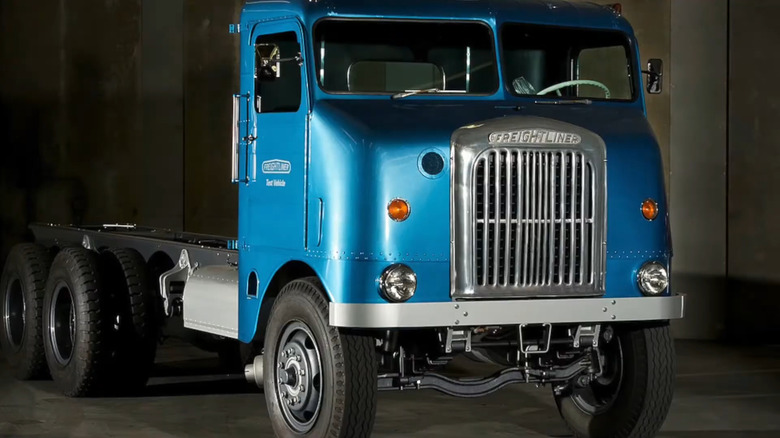 A beautifully restored, vibrant blue retro-futuristic Freightliner Bubblenose cab-over truck chassis.