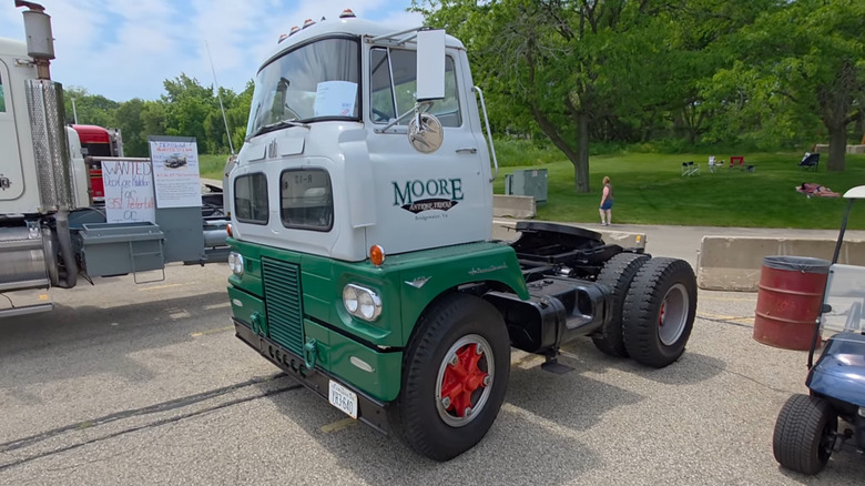 A high-riding International Harvester Sightliner cab-over truck chassis in white and green paint.