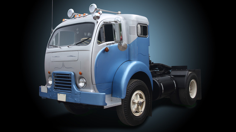 A 1967 White Model 3000 on a dark background. The blue and silver colors highlight the truck's Art Deco design.