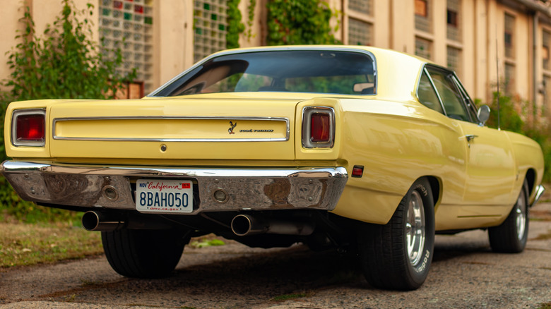 An close-up of an old 1970s two tone classic car parked.