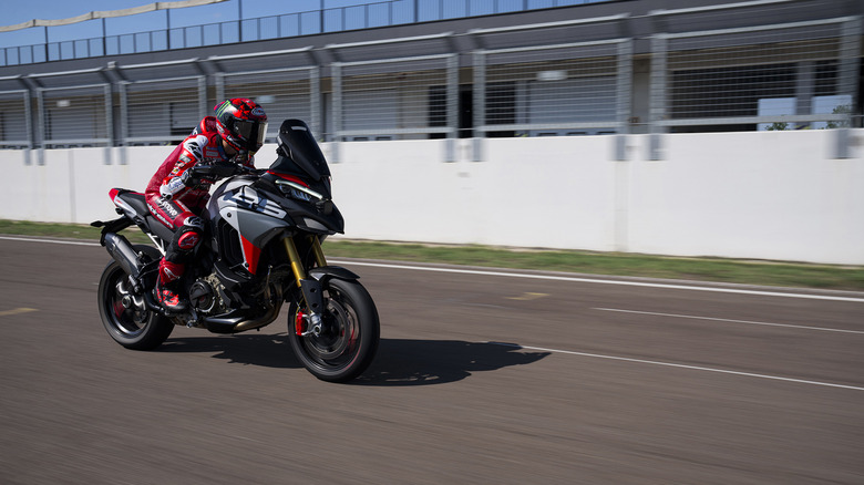 Ducati Multistrada V4 RS on a race track, rider in full race leathers