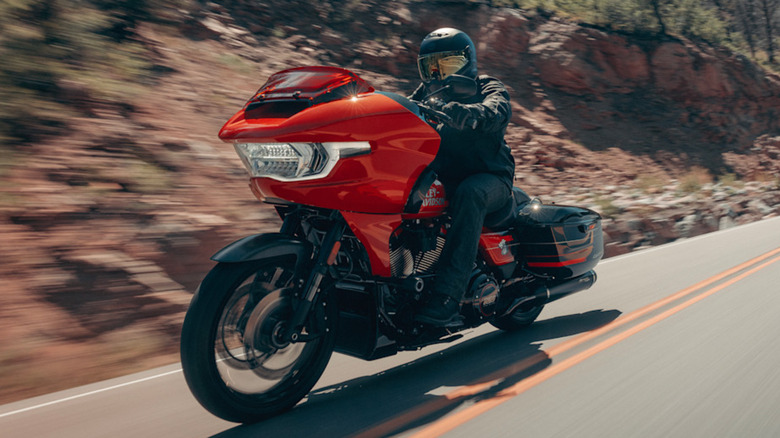 Harley-Davidson CVO Road Glide ST in orange being ridden on the highway